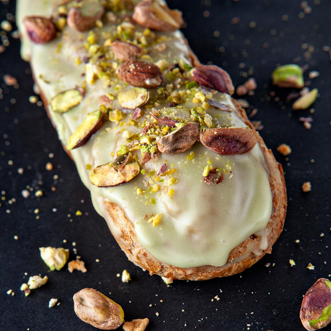 Image of a Pistachio Cream Puff with crushed pistachios on top