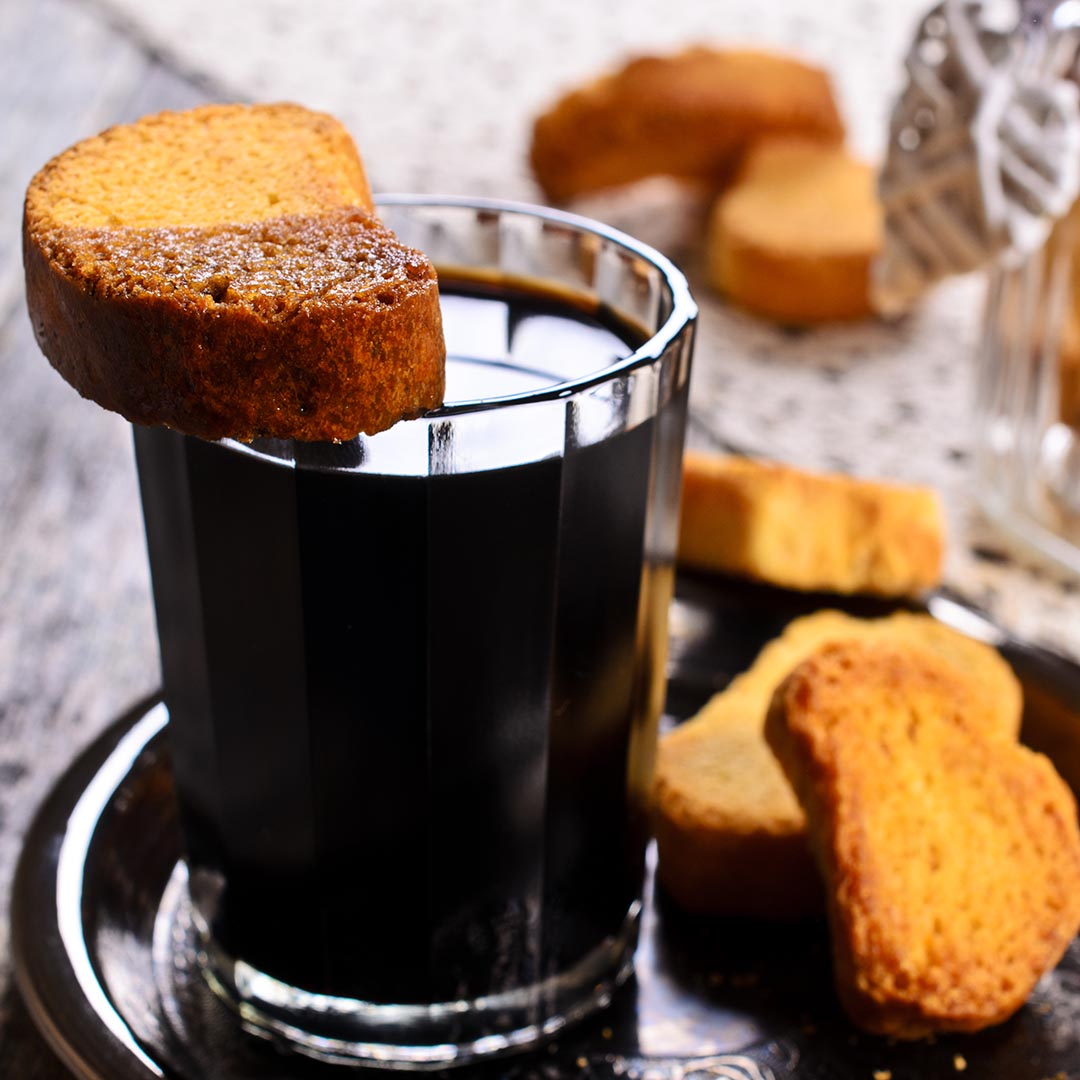 Chestnut biscotti dipped and on top of black coffee